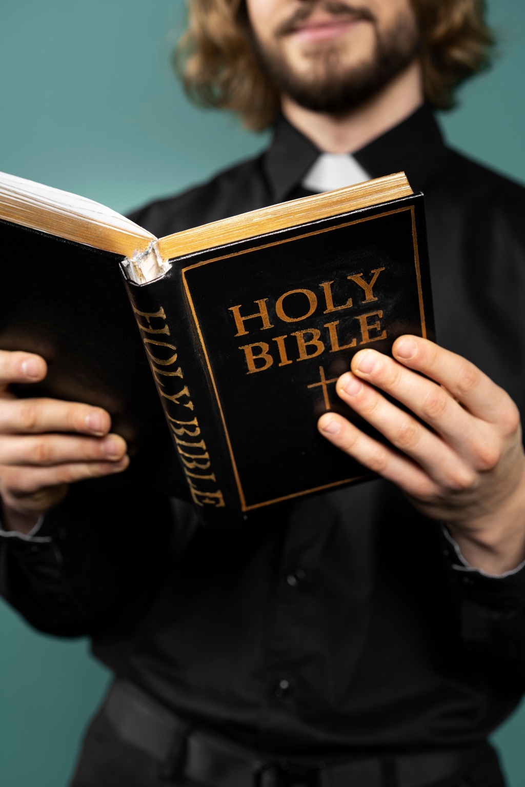Close up pastor holding bible